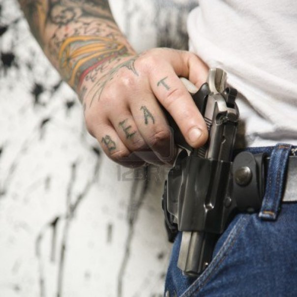 2145584-caucasian-tattooed-man-wearing-holster-with-gun